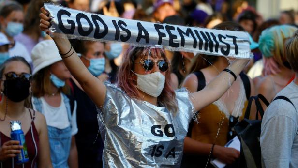 A protester displays a sloganat a demonstration during a women's strike in Zurich