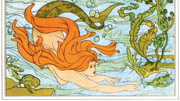 Eine Meerjungfrau mit roten Haaren schwimmt im Ozean, umgeben von Fischen und Algen.