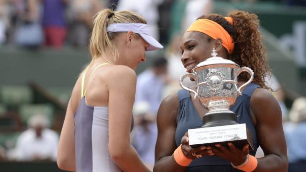 Serena Williams hält die Coupe Suzanne Lenglen, während Maria Sharapova daneben steht.