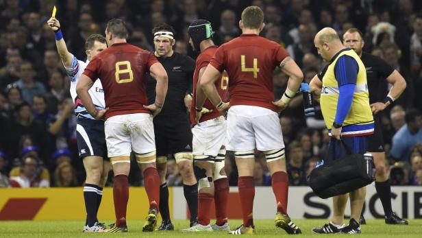 Ein Rugby-Schiedsrichter zeigt einem Spieler die gelbe Karte.