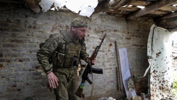 A Ukrainian serviceman is seen at a position in a frontline in Donetsk region