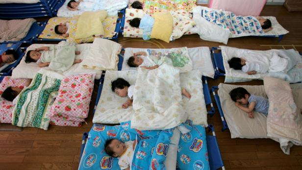 FILE PHOTO: Nursery school children take a nap at Hinagiku nursery in Moriyama