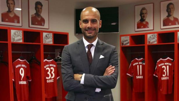 Bayern Munich new head coach Pep Guardiola poses in the team locker room inside the Allianz Arena June 24, 2013. Treble-winning Bayern Munich unveiled their new coach Guardiola amid a media frenzy on Monday as the Bavarians plan to extend their domination at home and in Europe. The Spaniard, who won 14 trophies in four years at Barcelona, has signed a three-year contract. REUTERS/Alexander Hassenstein/Pool (GERMANY - Tags: SPORT SOCCER)