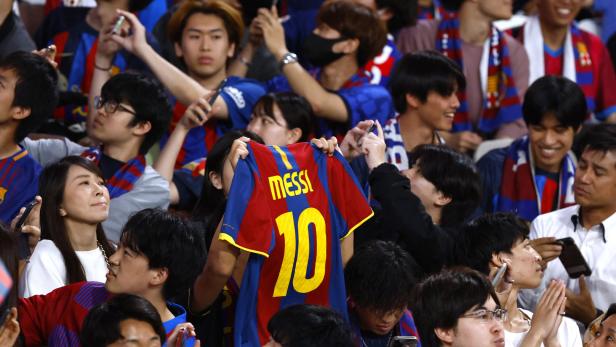 Fans halten ein Trikot mit der Aufschrift „Messi 10“ in die Höhe.