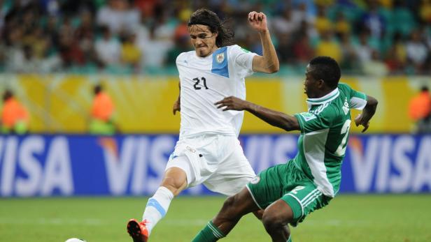 Edinson Cavani im Zweikampf mit einem nigerianischen Gegenspieler während eines Fußballspiels.