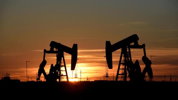 FILE PHOTO: Pump jacks operate at sunset in an oil field in Midland