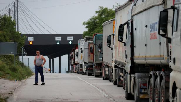 Trucks with goods queue at the Kosovo-Serbia border crossing in Merdare