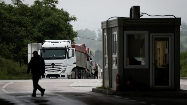 Trucks with goods queue at the Kosovo-Serbia border crossing in Merdare