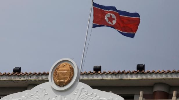 FILE PHOTO: The North Korean flag flutters at the North Korea consular office in Dandong