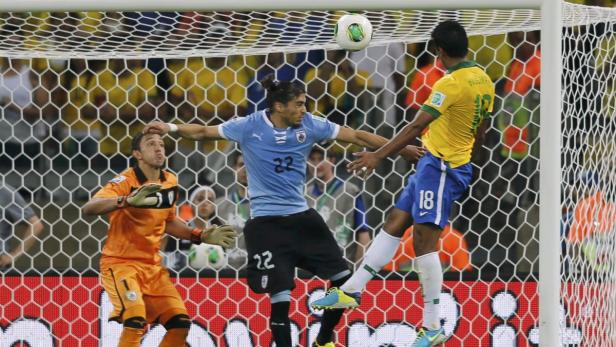 Ein Fußballspiel zwischen Uruguay und Brasilien vor einem gelben Tornetz.