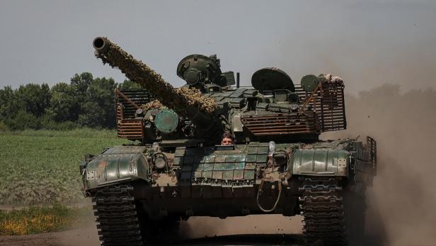 Ukrainian servicemen ride in a tank near a front line in Donetsk region