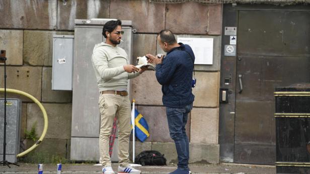 Protesters burn a Koran at a demonstration in Stockholm