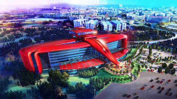 Ein futuristisches, rot-glänzendes Gebäude mit Glasfassade und Parkplatz in einer Stadtlandschaft.