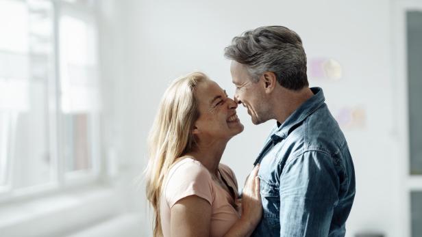 Affectionate couple touching noses at home - Stock-Fotografie
