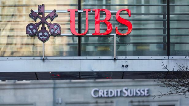 FILE PHOTO: Logos of Swiss banks UBS and Credit Suisse are seen in Zurich, Switzerland