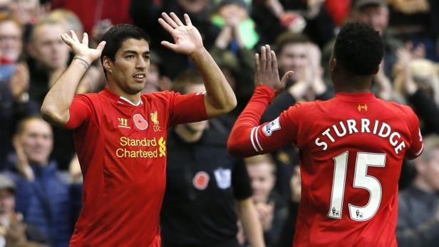 Liverpool's Suarez celebrates with teammate Sturri