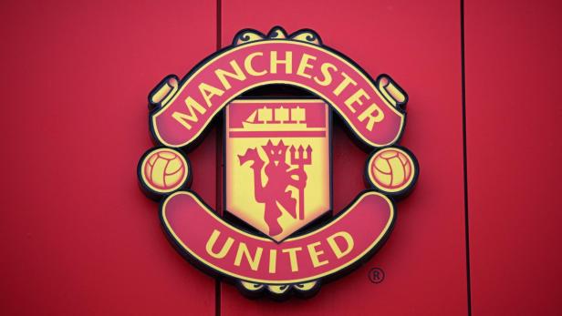 Das Logo von Manchester United auf einem roten Hintergrund.
