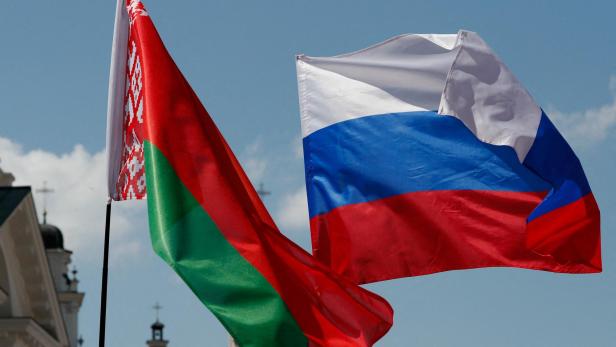 FILE PHOTO: Belarusian and Russian national flags fly during "Day of multinational Russia" event in central Minsk