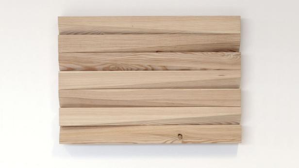 Mehrere helle Holzbretter sind horizontal an einer weißen Wand angebracht.
