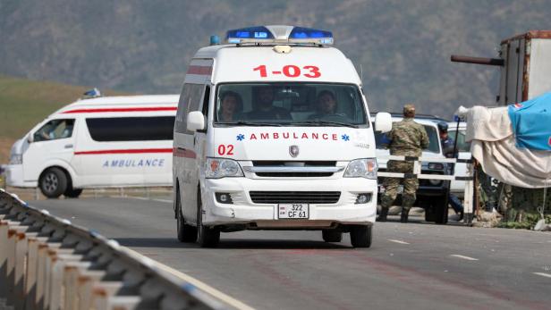 An ambulance heading from Nagorno-Karabakh region drives near Kornidzor