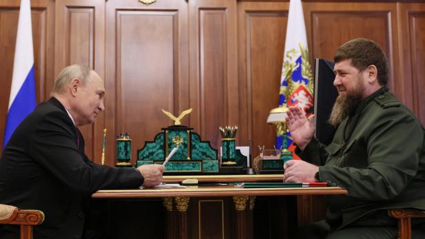Wladimir Putin und Ramsan Kadyrov sitzen an einem Tisch und unterhalten sich
