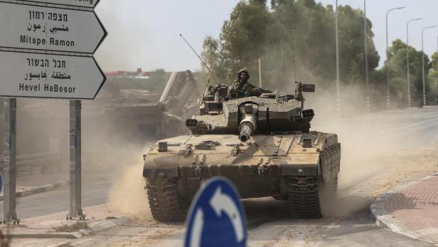 FILE PHOTO: Israeli soldiers drive in a tank by Israel's border with Gaza in southern Israel