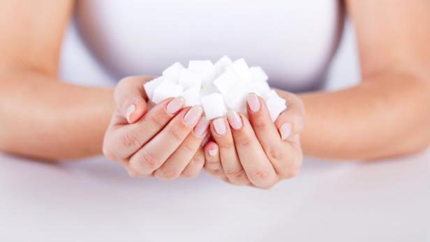 Woman holds in hands of sugar cubes