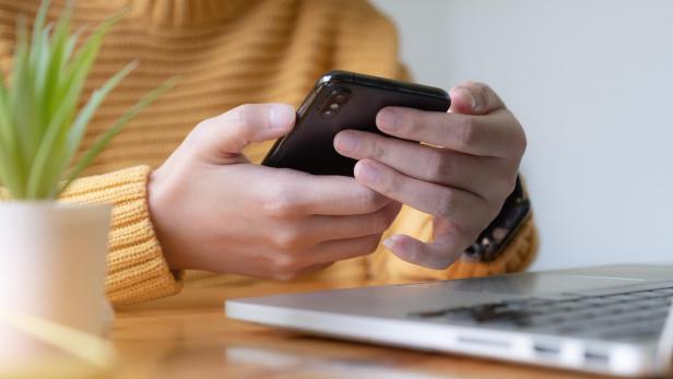 Young asian woman disconnect social and turn off her smartphone. Digital detox concept.