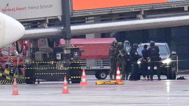 Police secure the area after a man drove through a barrier onto the grounds of the city's airport with a child in his car in Hamburg Police secure the area after a man drove through a barrier onto the grounds of the city's airport with a child in his car in Hamburg