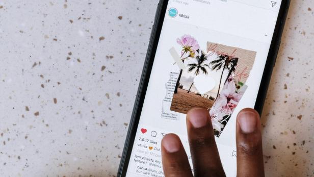 Instagram Nachrichten lesen, ohne gesehen: Trick Half Swipe hilft! Finger tippen auf den Bildschirm eines Smartphones und liken ein Bild auf Instagram