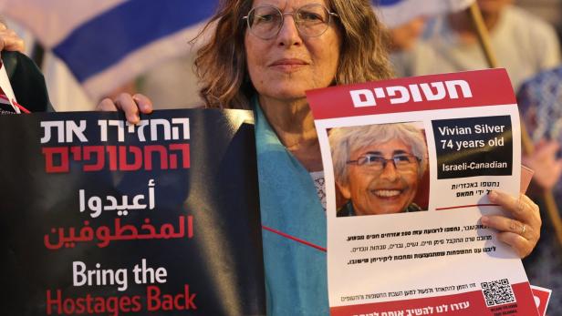Eine Demonstrantin hält ein Foto der Friedensaktivistin Vivian Silver in Jerusalem in Händen.
