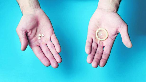 Pills and condom in the hands of men