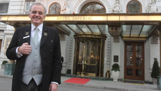 Ein Portier steht vor dem Hotel Imperial in Wien.