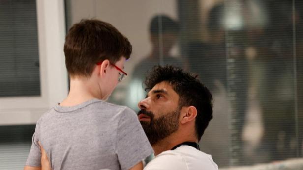 Ohad Munder, 9-year-old, reacts as he meets with his family member after he returned to Israel