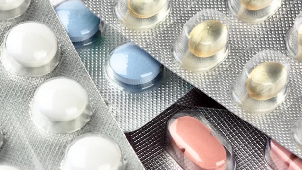 Mehrere Blisterpackungen mit verschiedenfarbigen Tabletten.