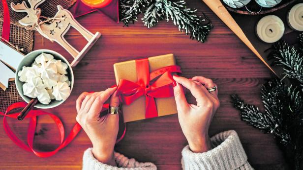 Woman wrapping Christmas gifts, overhead shot