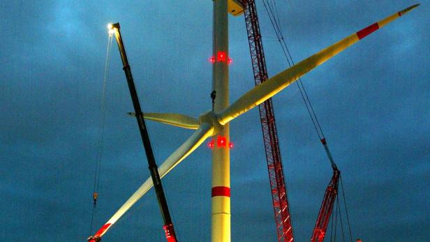 Cranes lift up the rotor of a giant wind generator in Brunsbuettel near Hamburg.