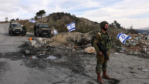 Israeli soldiers guard the road leading to the Homesh Yeshiva (religious school), located at the former settlement of Homesh, west of the West Bank city of Nablus.
