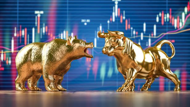 Golden bull and bear on stock data chart background. Investing, stock exchange financial bearish and mullish market concept.