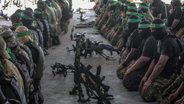 Al-Qassam brigade fighters march on the anniversary of the kidnapping of Israeli soldier Oron Shaul