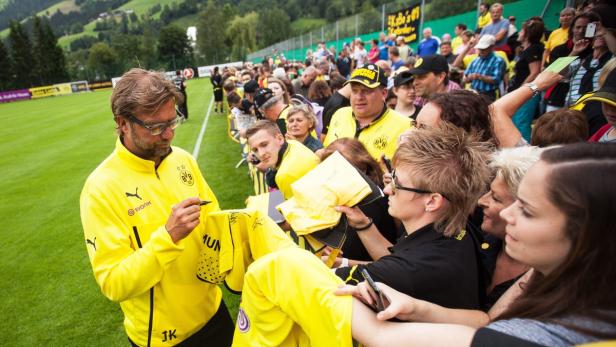 epa03774616 Borussia Dortmund&#039;s head coach Juergen Klopp (L) signs autographs during his team&#039;s training session at the training camp of the German Bundesliga side in Brixen im Thale, Austria, 04 July 2013. EPA/EXPA - JUERGEN FEICHTER