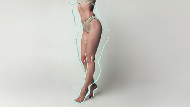 Cropped tender woman body in beige lingerie with drawn blue silhouette around body posing over studio background. body positivity