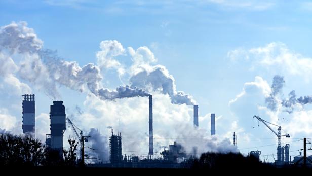 Air pollution from smoke coming out of factory chimneys.