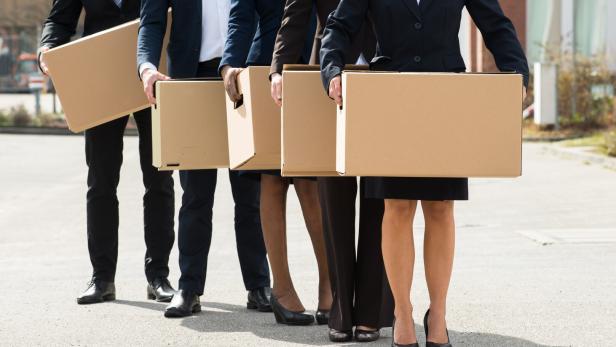 Businesspeople With Cardboard Boxes Standing In A Line