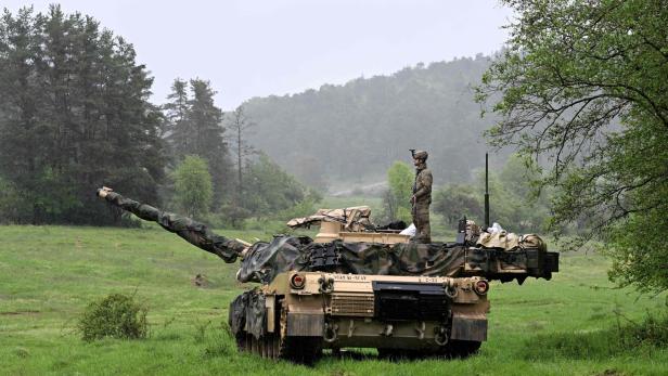 A US soldier stands on a US Army M1A2 Abrams tank during the Combined Resolve 18 exercise at the Hohenfels trainings area, southern Germany, on May 11, 2023. The United States on November 9, 2023, announced its approval of a $2.53 billion sale of M1A2 tanks and related equipment to Romania, a NATO ally that borders conflict-racked Ukraine. (Photo by Christof STACHE / AFP)         
