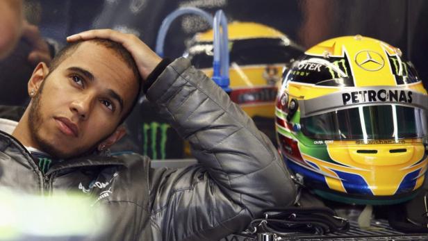 Mercedes Formula One driver Lewis Hamilton of Britain looks on in the garage during the third practice session of the Canadian F1 Grand Prix at the Circuit Gilles Villeneuve in Montreal June 8, 2013. REUTERS/Chris Wattie (CANADA - Tags: SPORT MOTORSPORT F1)