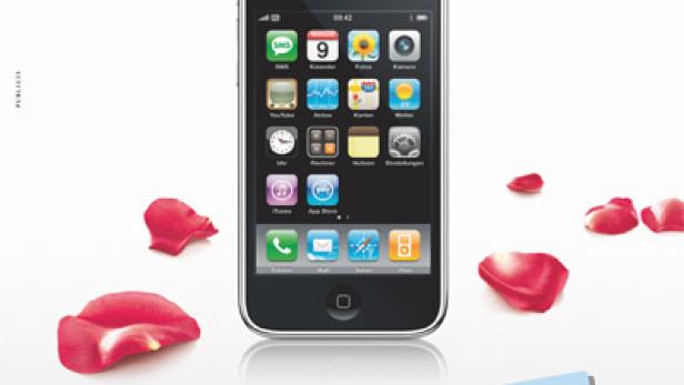 Ein iPhone 3G liegt neben roten Rosenblättern.