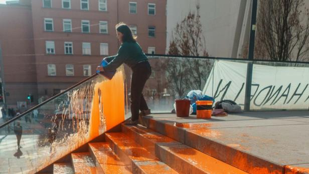 Klima-Aktivisten überschütteten Uni-Treppe mit oranger Farbe