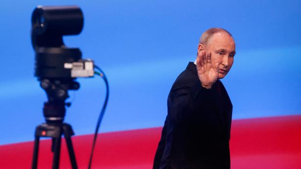 Russian incumbent President Putin leaves following his speech, in Moscow