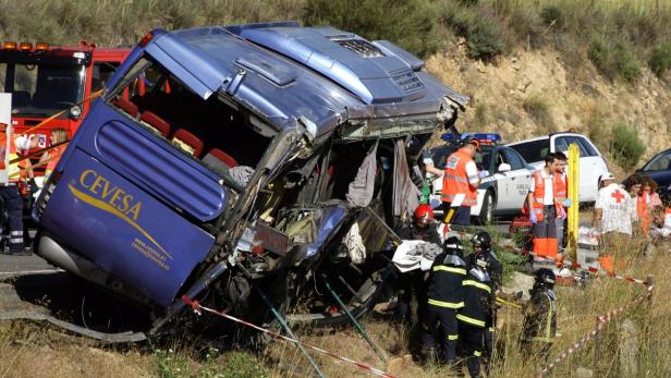 Firefighters recover a body from the wreckage of a
